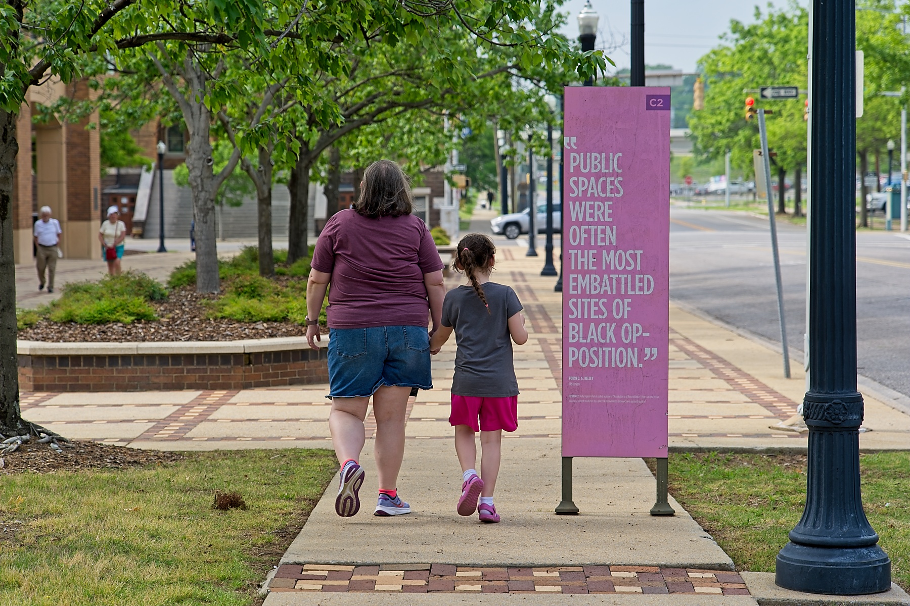Mom and daughter walking towards museum. Mom and daughter walking towards museum.