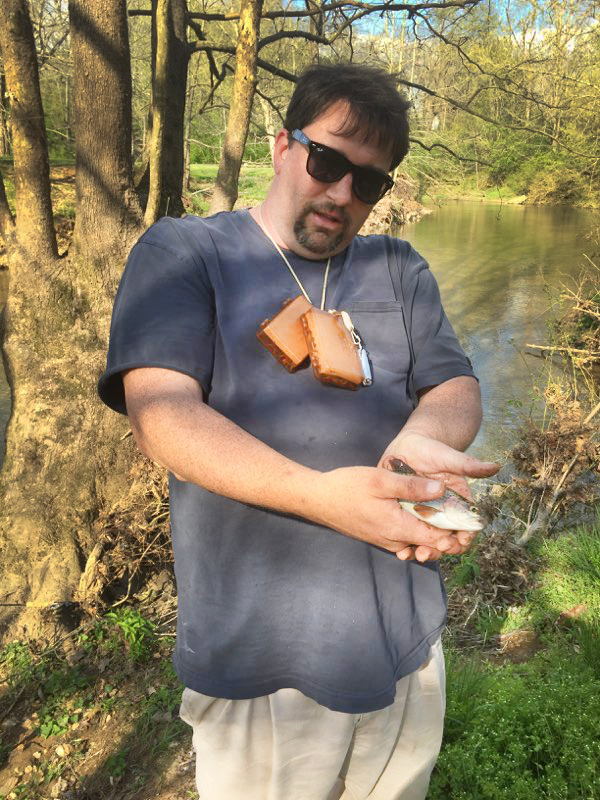 older dads josh with small trout Guy showing off little trout.