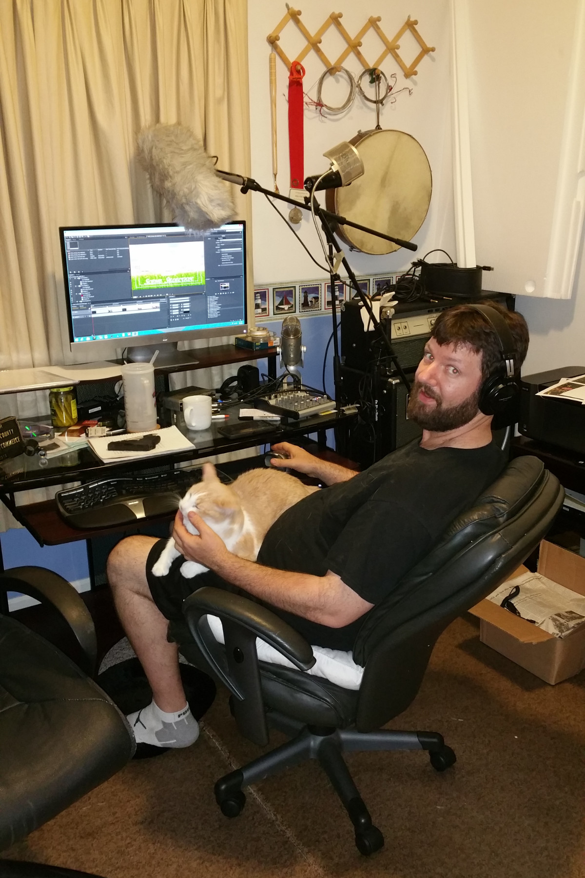 older dads me with gun and cat editing room Guy in editing desk.